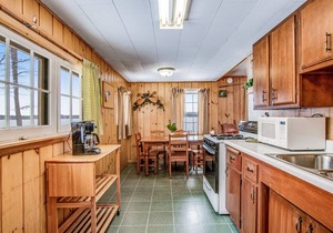All-season lakefront cabin at Scott’s Twin Lake Resort with sunroom, beach, dock