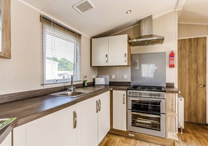 Modern and contemporary 12ft-wide caravan with one double and one twin.
