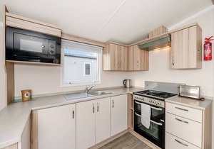 Modern and spacious 12ft-wide caravan with one double and two twin.