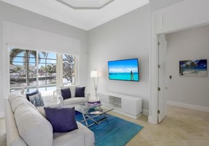 SW exposure home on wide canal with pool and spa