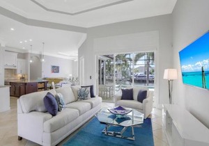 SW exposure home on wide canal with pool and spa
