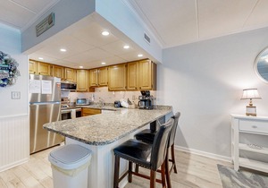 Updated ocean-view condo with beach access, patio, central AC & washer/dryer