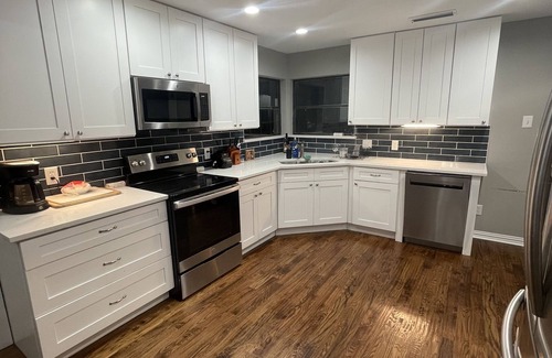 Lake Highlands House | 1 bedroom suite in remodeled luxury home. private hallway, bed, bath.