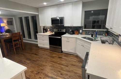Lake Highlands House | 1 bedroom suite in remodeled luxury home. private hallway, bed, bath.