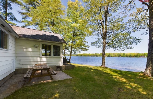 Munising Cabin | 16 Mile Lake Getaway-Lakefront with Water Toys & Family Time Around a Fire