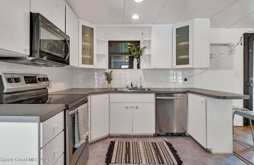 Cocoa House | 3 bed/2 bath house with tropical backyard, pool, fenced yard, hammock