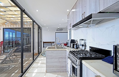 El Sargento House | 3 bedroom, 3 bath premium repurposed shipping container home. Game room w/darts, shuffleboard, video game cabinet, Infinity game table, new 8 person hot tub, multiple decks w/firepits, fast Wifi (250 mb+)w/Starlink backup. Free use of two SUPs.