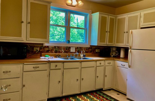 Manistique Cottage | 3BR/1.5BA Woodsy Stone Cottage 1 Hr to Pictured Rocks, Hike Trails On-Property