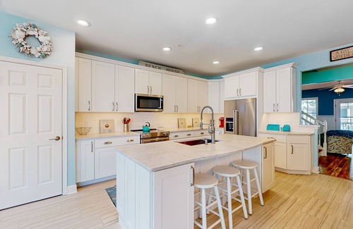 Sunset Island House | 4-story townhome with resort pools, beaches, water access, & great location