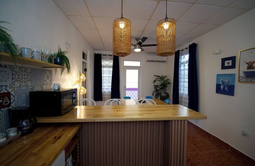 Mayaguez Pueblo Apartment | 5.9 Purple Casita w/historic balcony