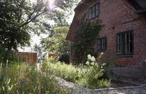 Rodenas House | 5* thatched roof house Ziegelmacher Achten 6600sqm natural garden with pond and outdoor sauna