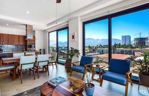 North Hotel Zone Condo | 5th-floor condo with partial ocean views, heated pool, sauna, gym, balcony, W/D