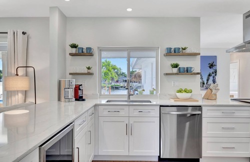Tropic Palms House | 796 Serene 4BR Villa: Heated Pool, Tiki Hut & Waterfront Views in Delray Beach!