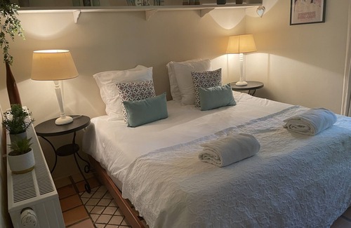 Villamblard Bed & Breakfast | A beautiful romantic bedroom with a mezzanine area, bathroom and private garden