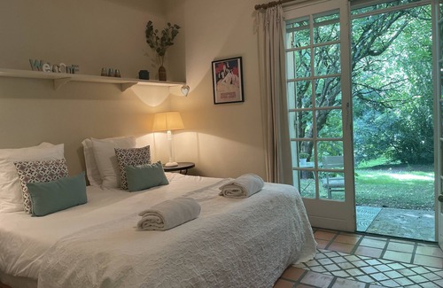 Villamblard Bed & Breakfast | A beautiful romantic bedroom with a mezzanine area, bathroom and private garden