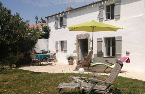 Bouin Cottage | a charming little house deep in a fenced garden with stone walls