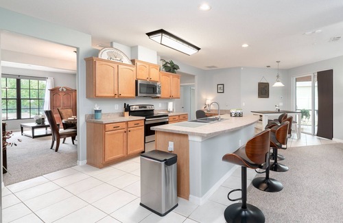 Wedgefield House | A peaceful tropical oasis with a large saltwater pool and spa hot tub.