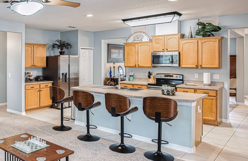 Wedgefield House | A peaceful tropical oasis with a large saltwater pool and spa hot tub.