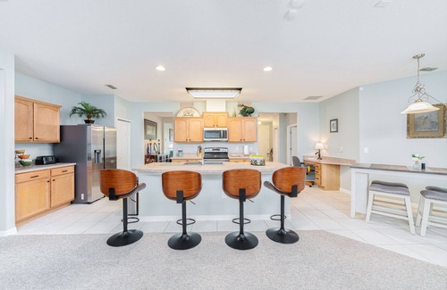 Wedgefield House | A peaceful tropical oasis with a large saltwater pool and spa hot tub.