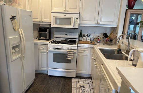 Sabre Springs Condo | A room wt a queen bed and room with 2 twin beds; an attached,interior bathroom.