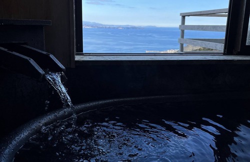 Shimotaga House | A spectacular view! Relax on the sea-view terrace/Scandinavian log house with hot spring & fireplace