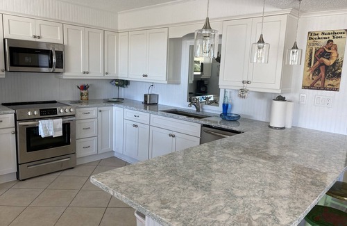 East End Condo | Adorable Beach Cottage. Full size swimming pool shared by four units in building