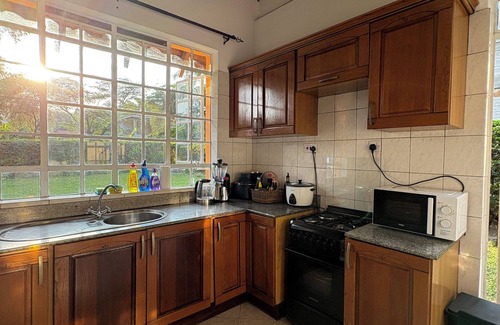 Arusha Villa | Amora Villa, Cozy home with a beautiful lush garden, swimming pool, fitness gym.