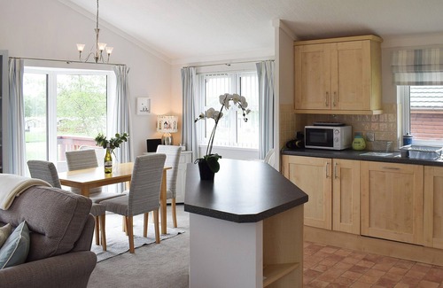 Swarland Cottage | An elegant lodge with lovely raised deck to relax overlooking the golf course.