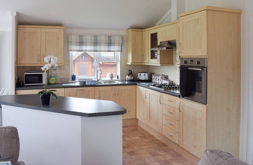 Swarland Cottage | An elegant lodge with lovely raised deck to relax overlooking the golf course.
