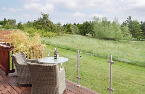 Swarland Cottage | An elegant lodge with lovely raised deck to relax overlooking the golf course.