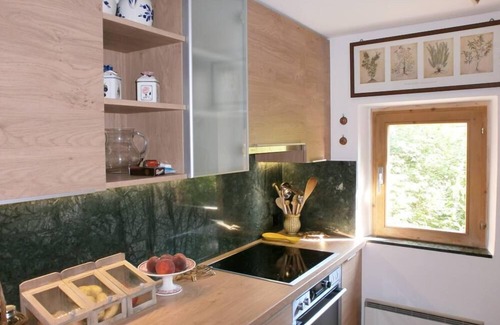 Sent House | Ancient typical Engadine mill on a stream near the woods and walks