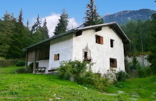 Sent House | Ancient typical Engadine mill on a stream near the woods and walks