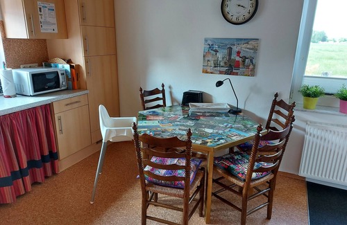 Varel Condo | Apartment and more . Creative garden with fire pit and barbecue