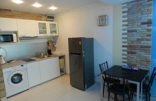 Jomtien Apartment | Apartment bedroom + living room.