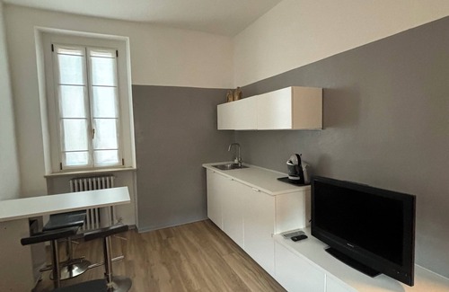 Treviglio Apartment | Apartment with a terrace among the rooftops of an old building.