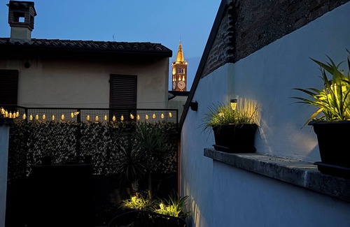 Treviglio Apartment | Apartment with a terrace among the rooftops of an old building.