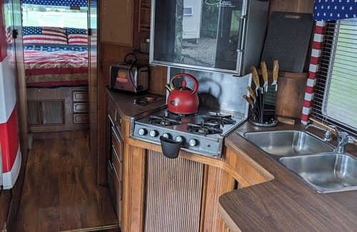 North Wheatley House | 'Arvey the American RV, parked on a picturesque campsite with its own garden