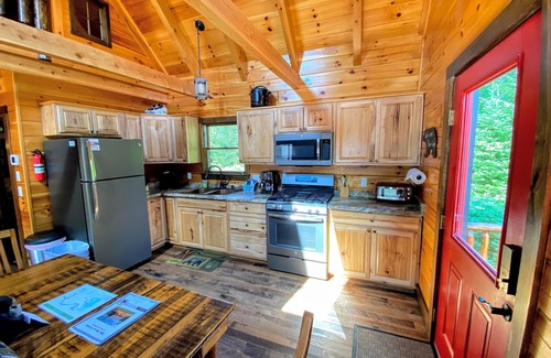 Bretton Woods Cabin | BC Log cabin 1 mile from skiing, beach, slope views! Hot tub, ice skating, and dog friendly!