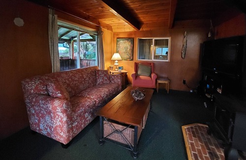 Grayland House | Beach Cabin with covered front porch and back deck with gardens and fire pit