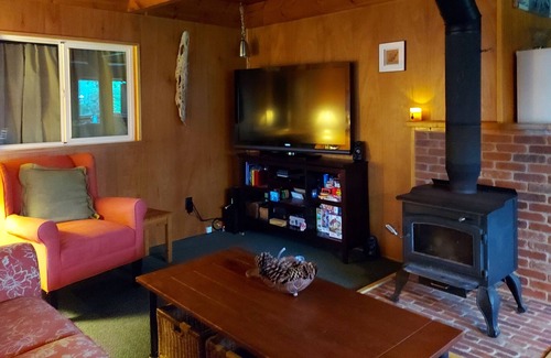 Grayland House | Beach Cabin with covered front porch and back deck with gardens and fire pit