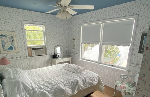 Gwinn Cottage | Beach front lake home, sleeps 8, hot tub, lots of outdoor spaces, docks.