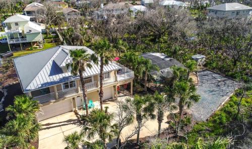 Marineland Acres House | Beach Home with Amazing Oasis Pool Spa Waterfall Fire Pit Bikes