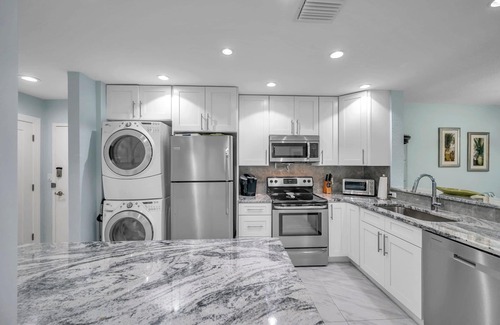Madeira Beach Condo | Beachfront Bliss - King Bed - Heated Pool - Steps to John’s Pass & Dining!