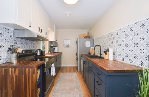Courtenay House | Beachfront Cottage: Brick Fireplace + Ocean Deck