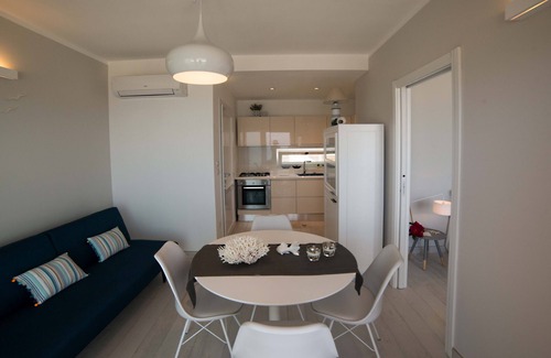 Torre San Giovanni Apartment | Beachfront 2nd floor apartment with terrace located east with sunset