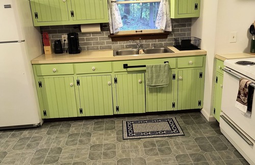 Shore House | Beautiful cabin situated on wooded land with nice yard clearing and small stream