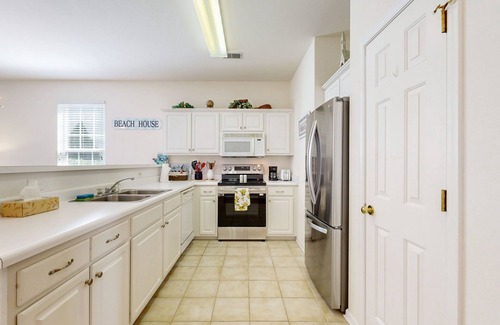 Sunset Beach Condo | Beautiful dog-friendly coastal home close to beach, AC, and shared pool.