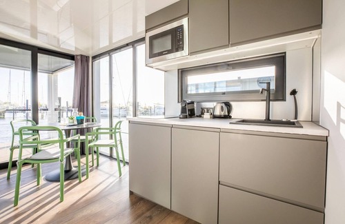 Volendam Boat Rental | Beautiful houseboat with shared pool