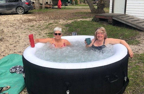 Manitoba RV Rental | Beautiful RV with a hot tub, at Ofty's Riverside Campground.
