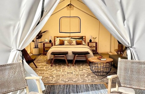 Levan House | Beautiful wall tent on sandy beach at waters edge